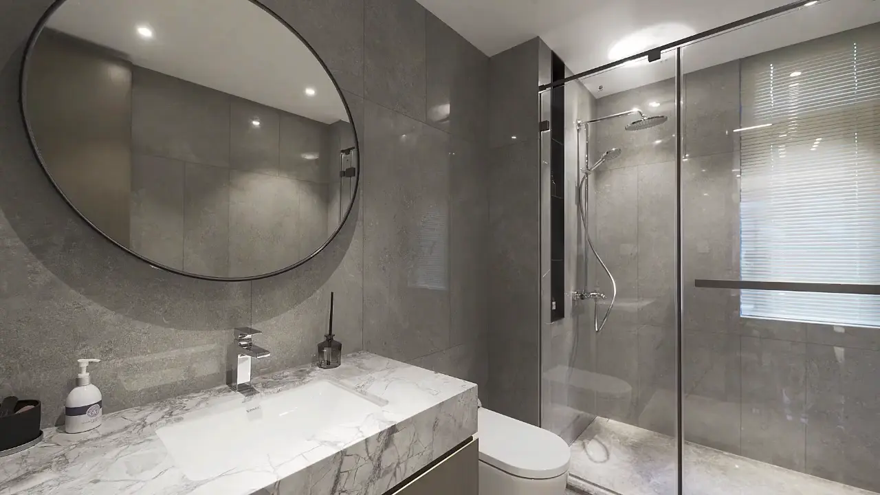 Modern bathroom with large gray wall tile, a glass walk-in shower and a marble vanity