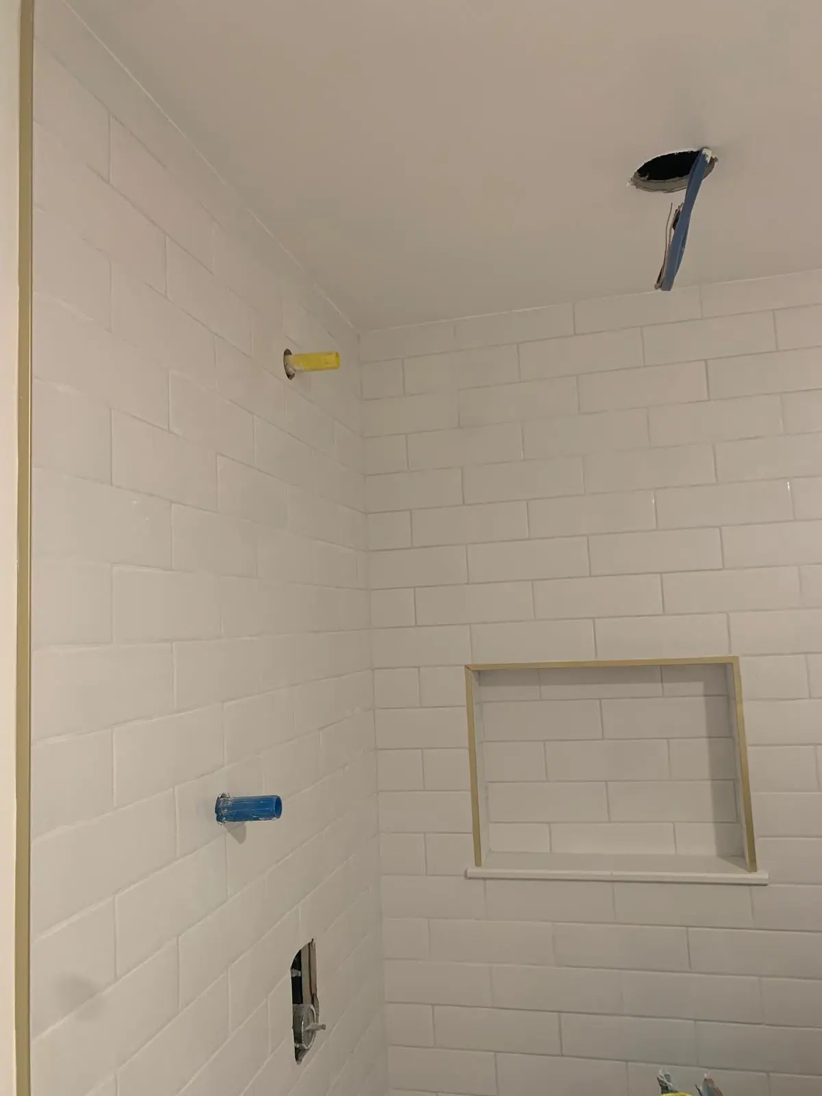 White subway tile wall with a recessed niche